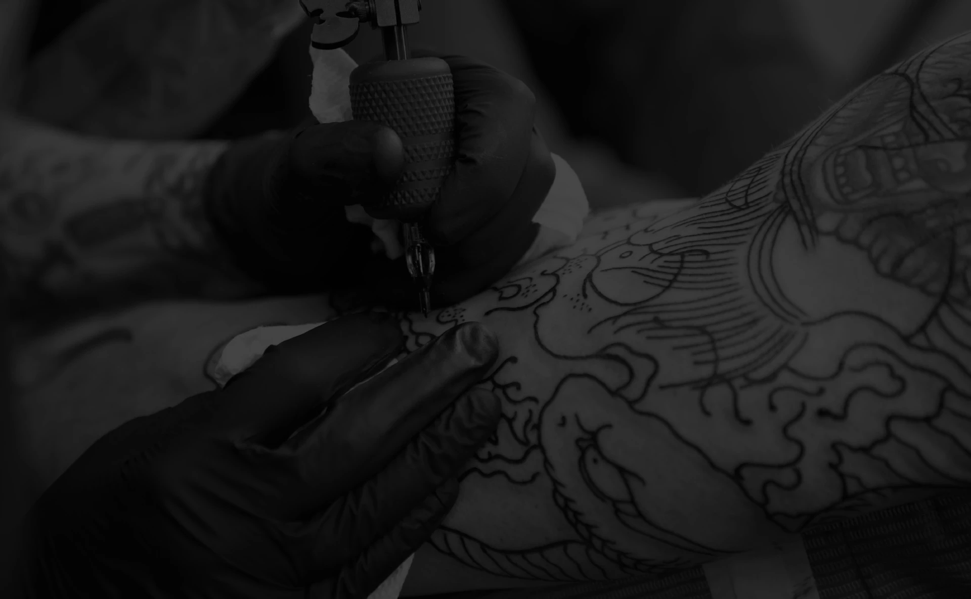 artist covering up tattoo black white