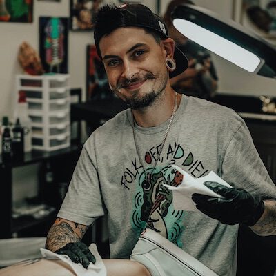 Cory is a skilled tattoo artist with 12 years of experience in American Traditional tattoos, known for his vibrant use of bold colors and diverse line weights. His passion for blending classic and new designs has made him a favorite among enthusiasts of this timeless style.