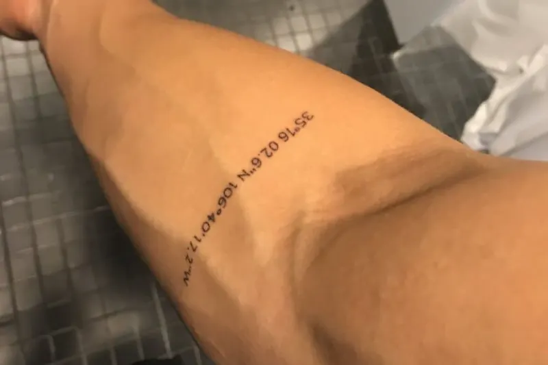 minimalist tattoo forearm gps coordinates