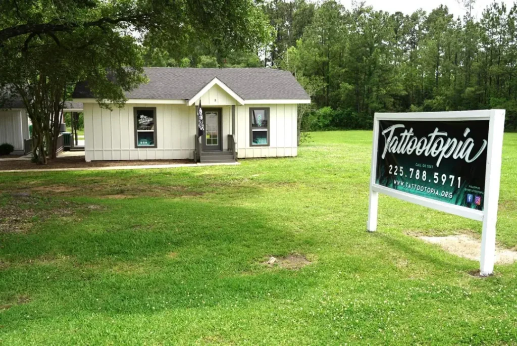 front of tattootopia in denham springs on florida with new sign