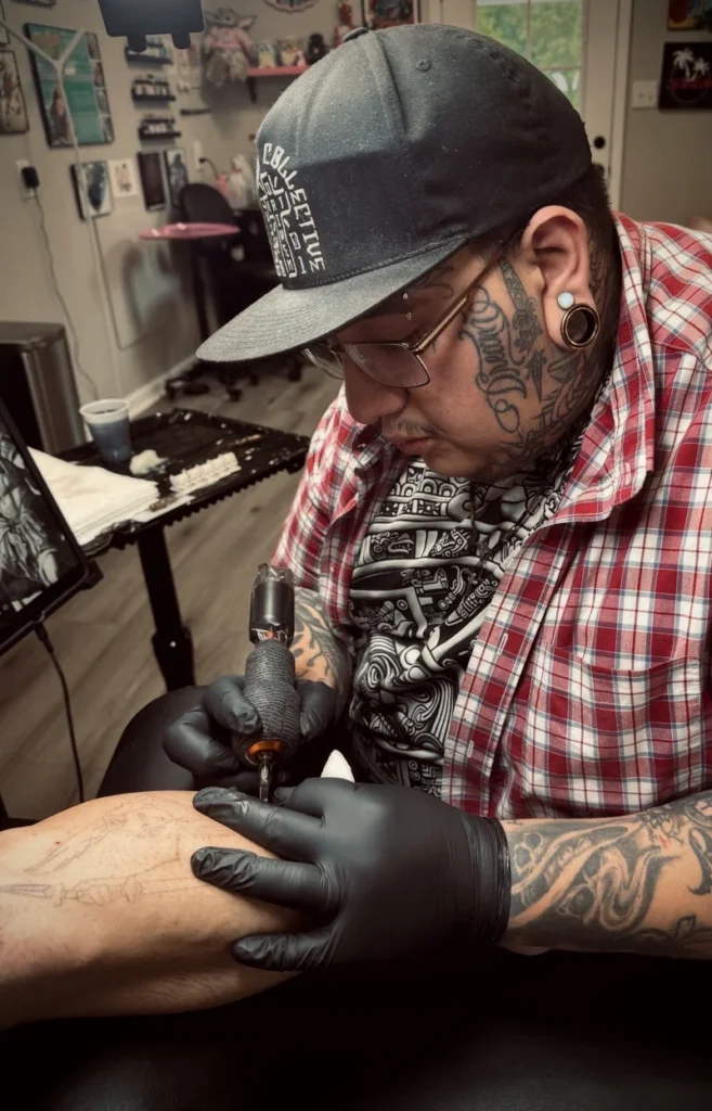 roger from tattootopia working on forearm tattoo