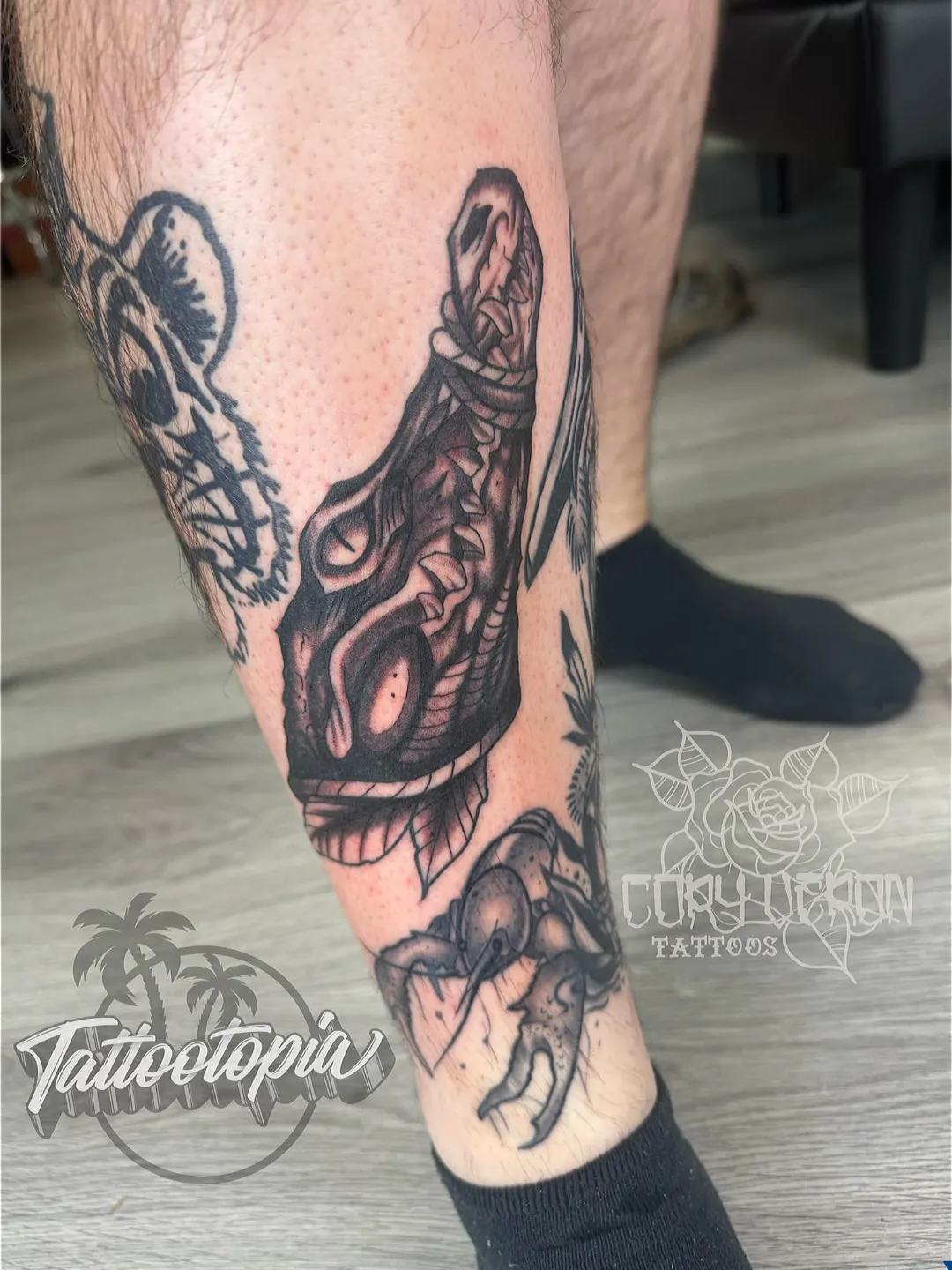 black and gray dinosaur skull scorpion leg tattoo cory veron tattootopia