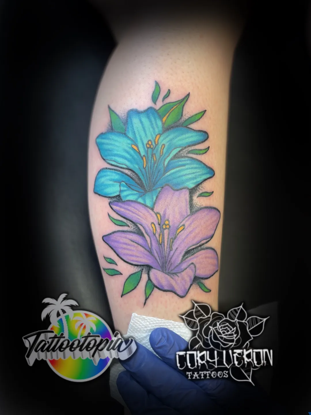 blue and purple lilies floral leg tattoo cory veron tattootopia