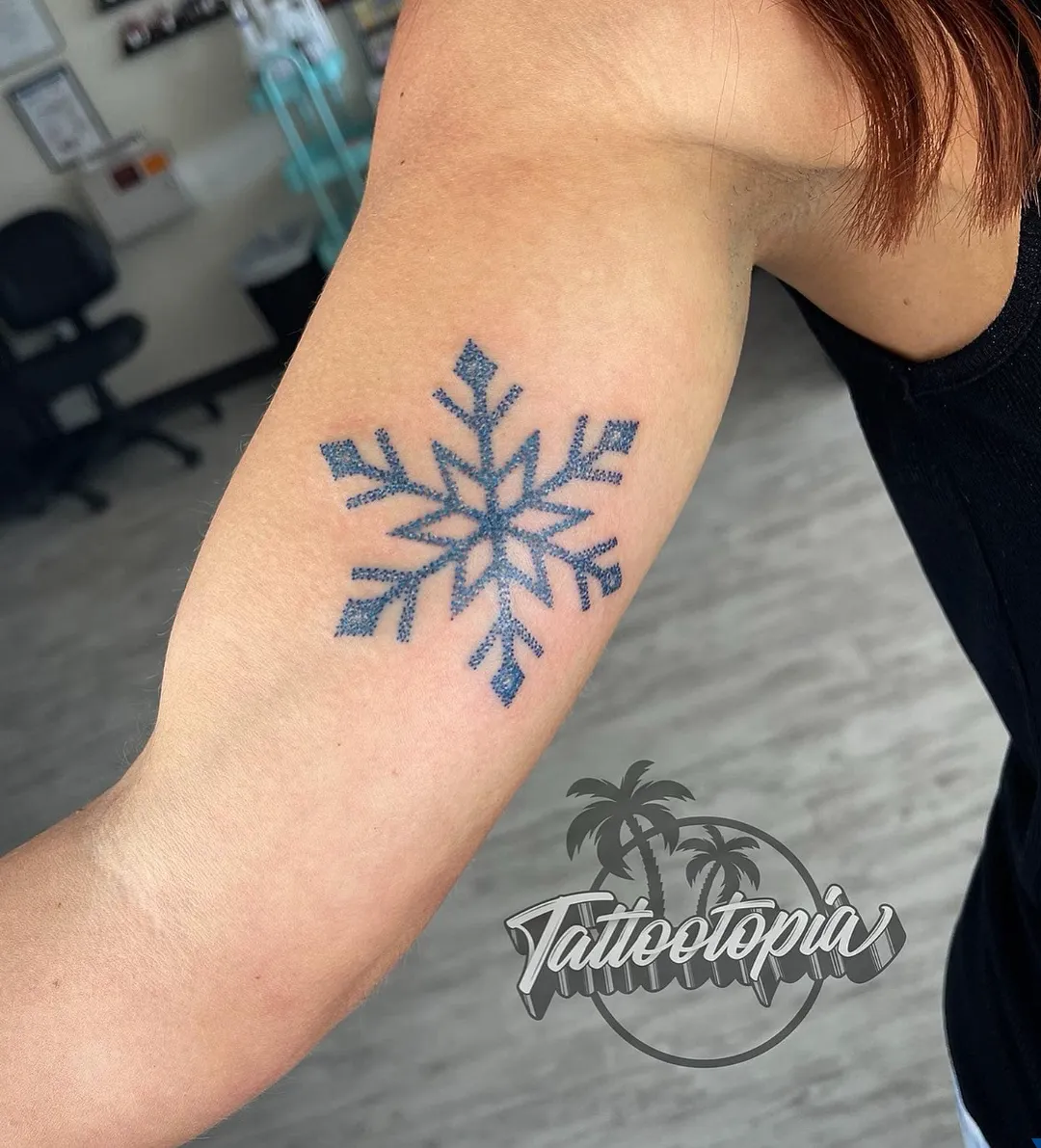 blue dotwork snowflake bicep tattoo cory veron tattootopia