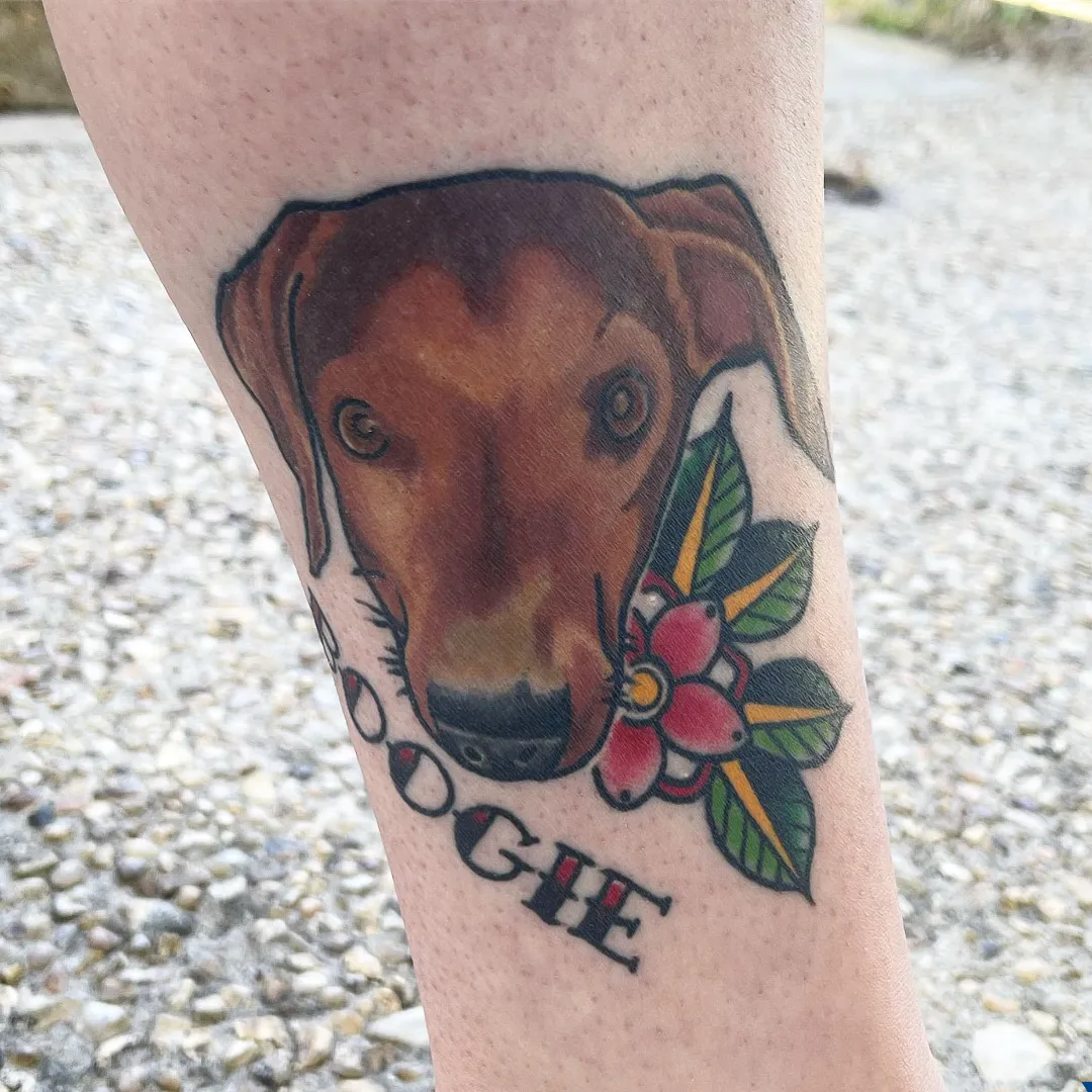 realistic dog portrait with flower leg tattoo cory veron tattootopia
