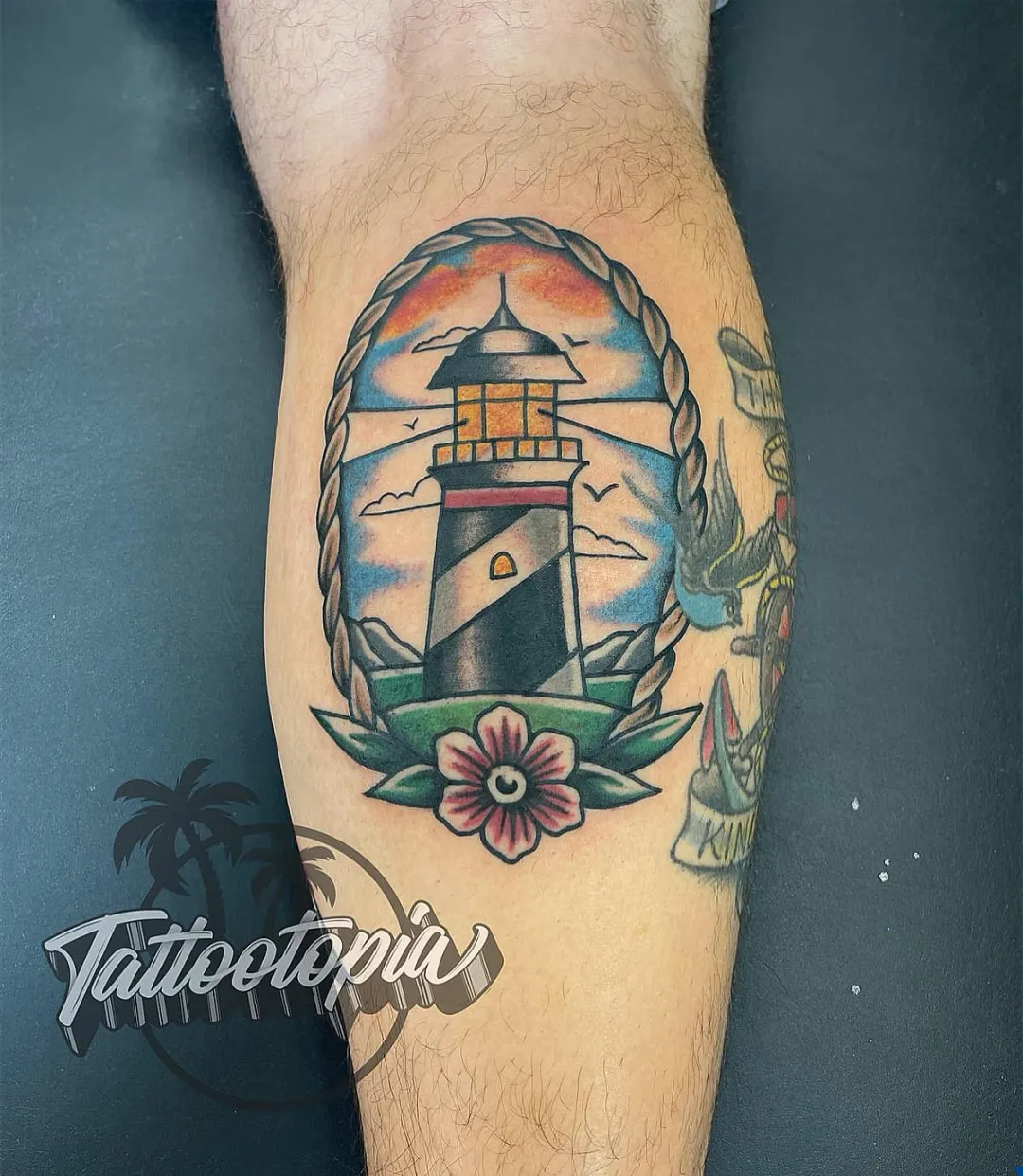 traditional lighthouse with flower leg tattoo cory veron tattootopia