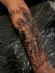 black and gray angel statue forearm tattoo jeff thibodaux tattootopia