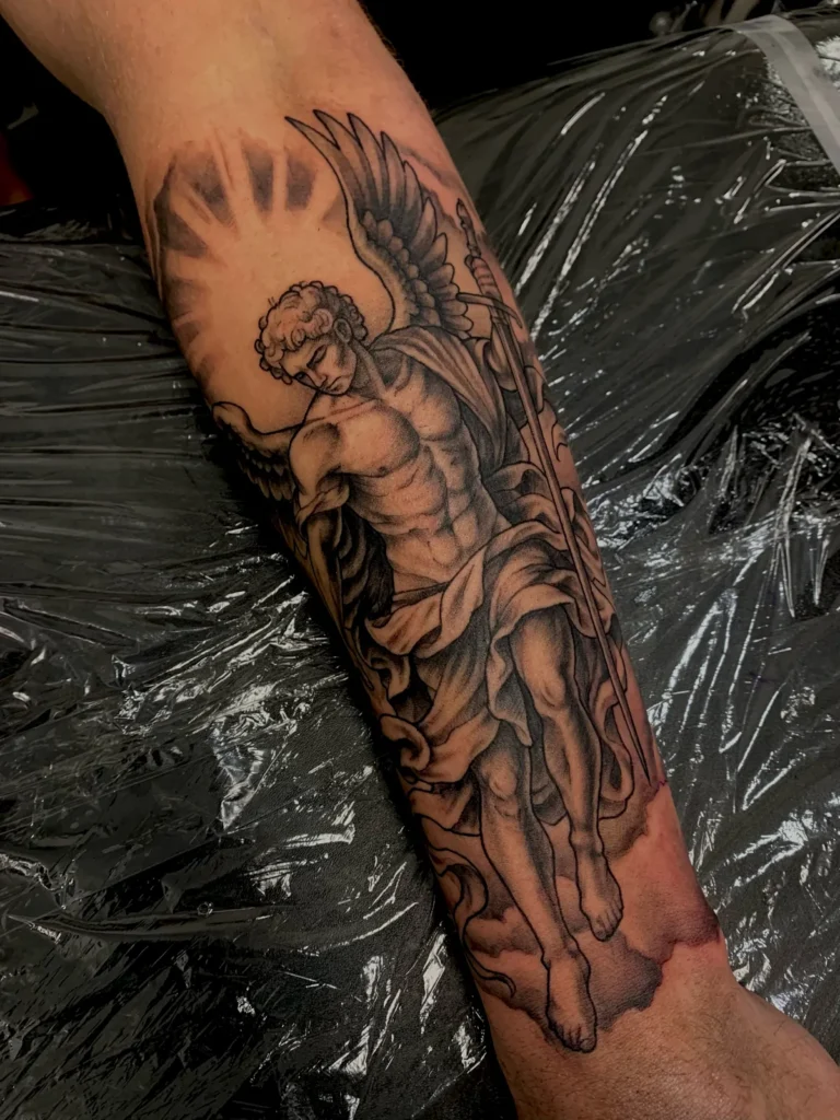 black and gray angel statue forearm tattoo jeff thibodaux tattootopia