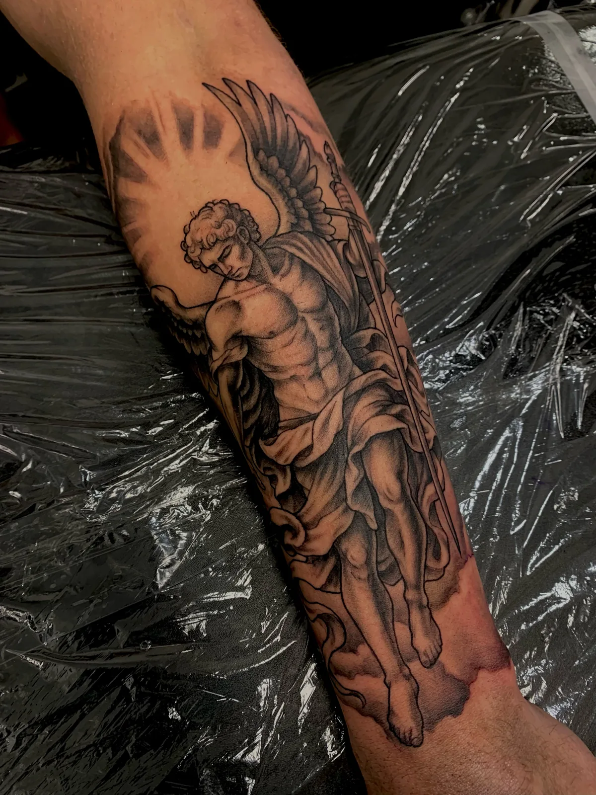 black and gray angel statue forearm tattoo jeff thibodaux tattootopia