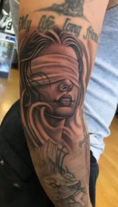 black and gray blindfolded woman portrait arm tattoo halo minier tattootopia