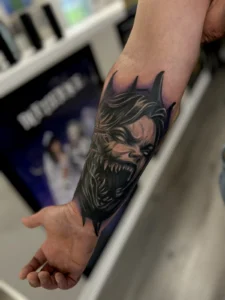 black and gray comic villain portrait forearm tattoo jeff thibodaux tattootopia