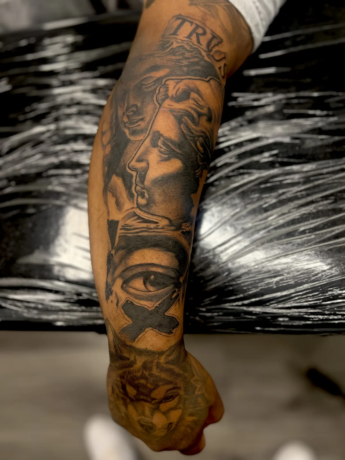 black and gray face and eye sleeve arm tattoo jeff thibodaux tattootopia