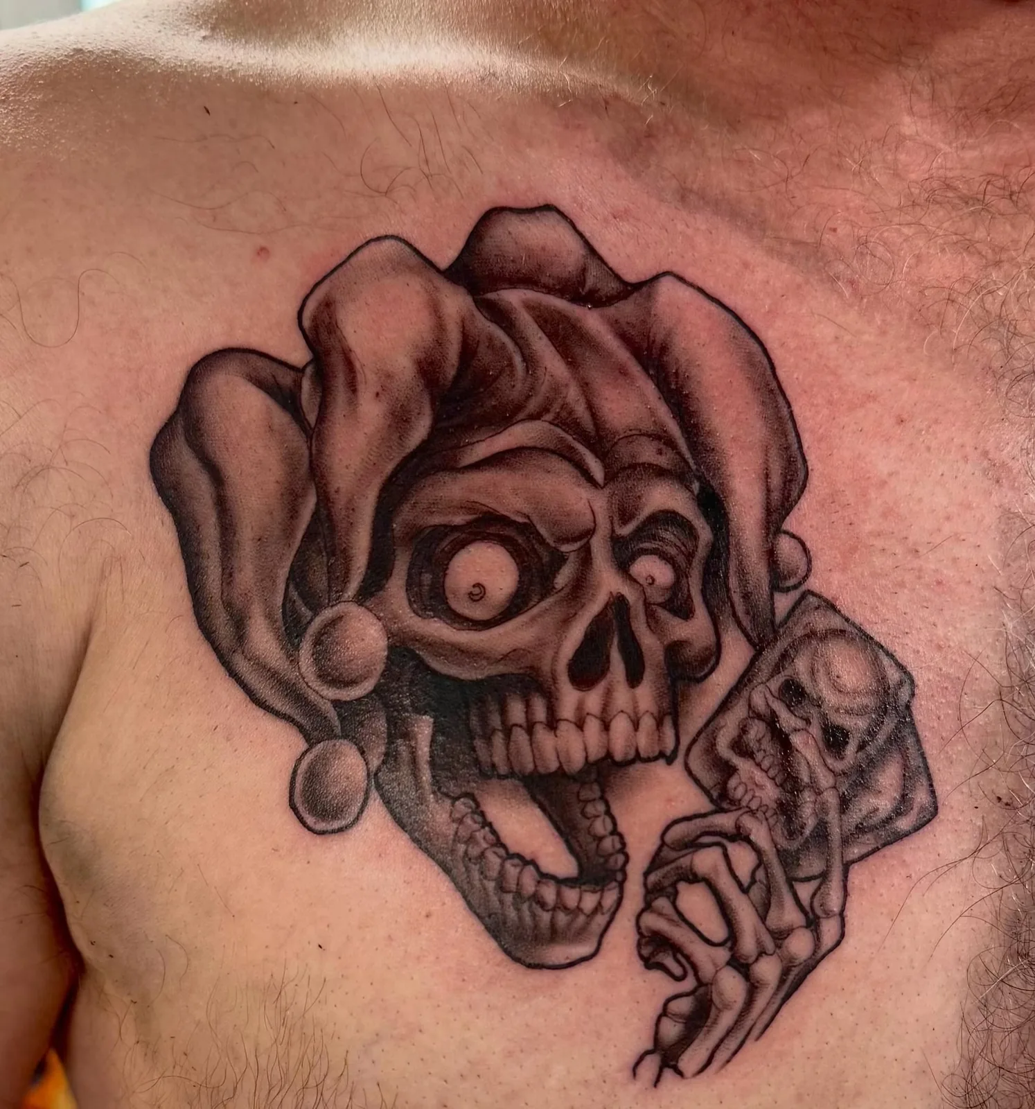 black and gray jester skull and roses chest tattoo josh lockhart tattootopia