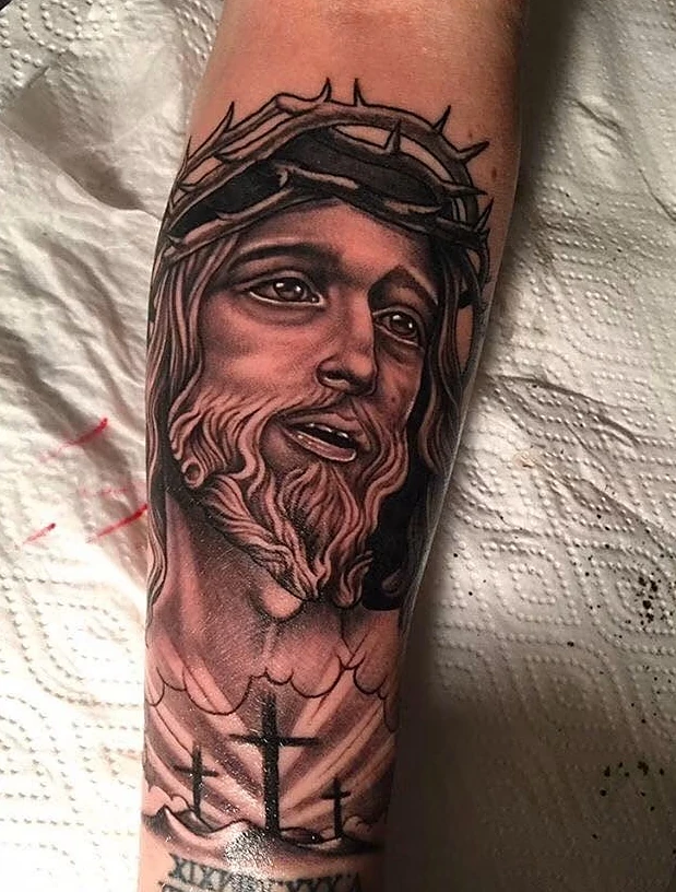 black and gray jesus crown of thorns arm tattoo halo minier tattootopia