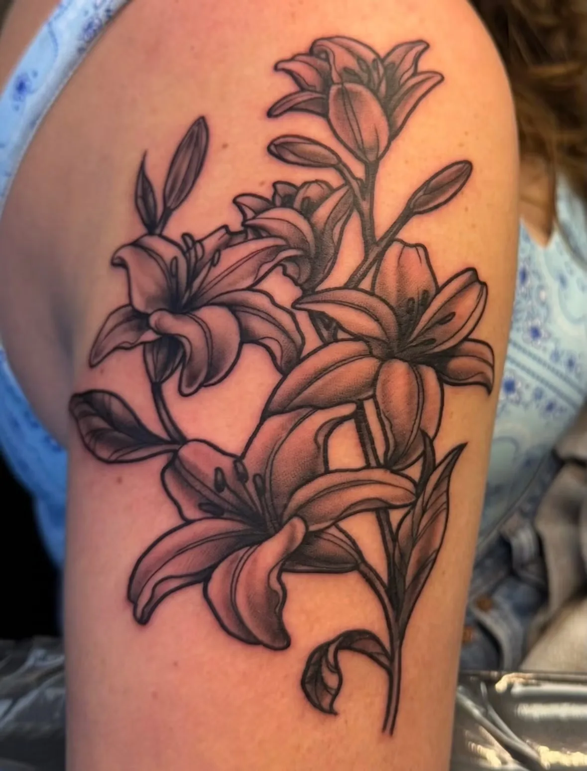 black and gray lilies upper arm tattoo josh lockhart tattootopia