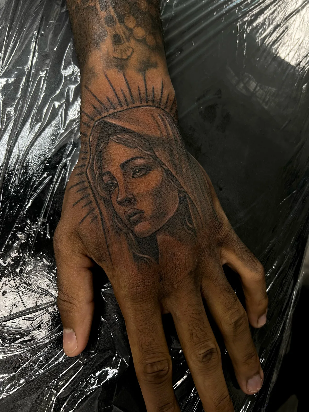 black and gray madonna portrait hand tattoo jeff thibodaux tattootopia