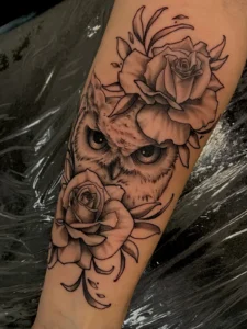 black and gray owl and roses arm tattoo jeff thibodaux tattootopia