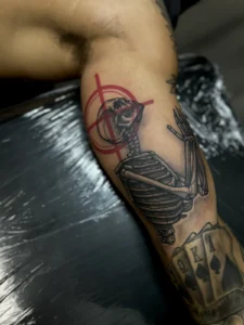 black and gray skeleton and playing cards arm tattoo jeff thibodaux tattootopia