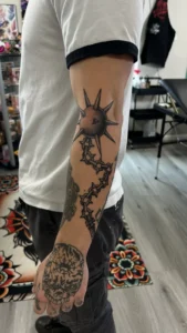 black and gray sun and mandala sleeve arm tattoo jeff thibodaux tattootopia