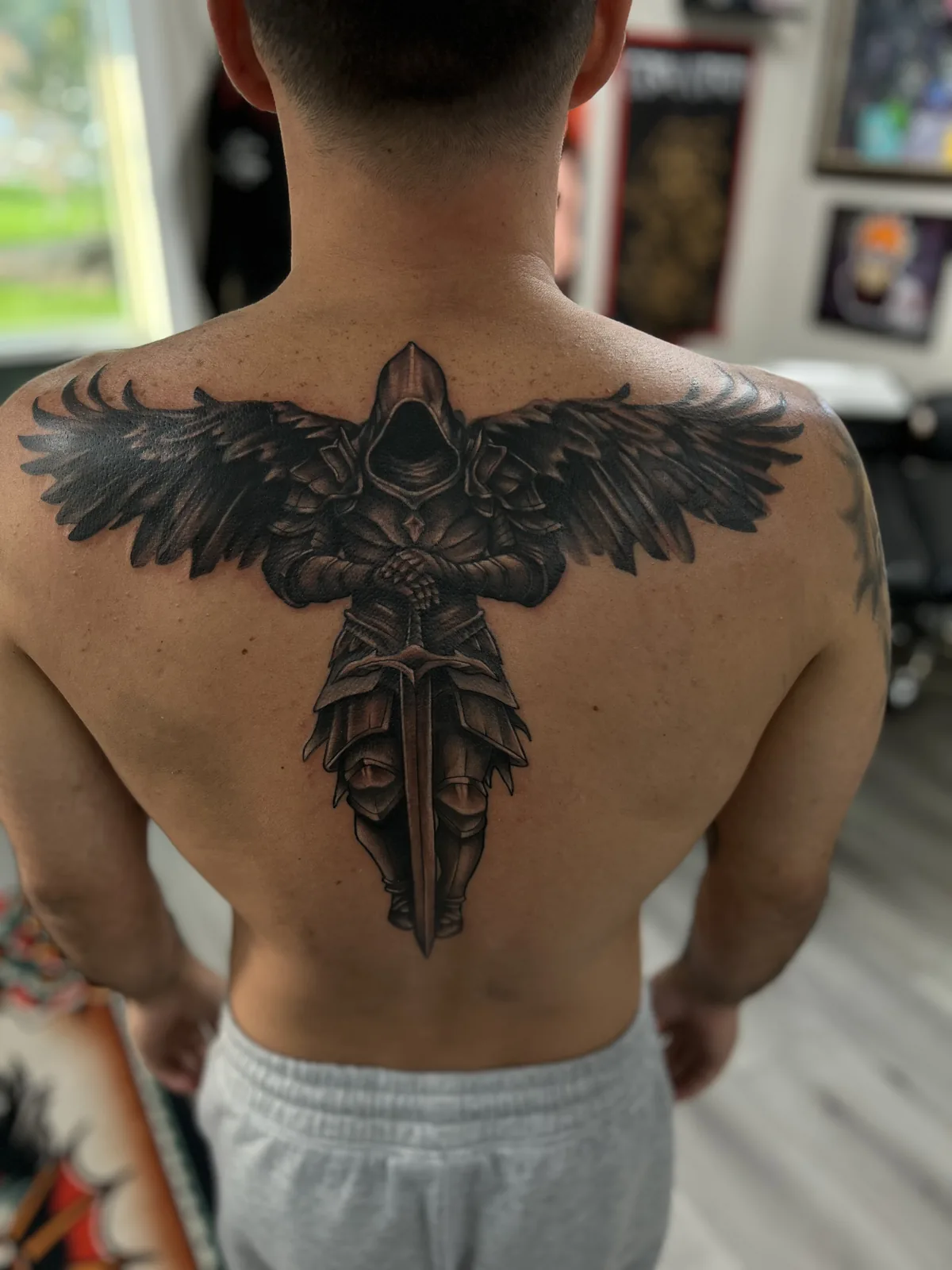 black and gray winged sword back tattoo jeff thibodaux tattootopia