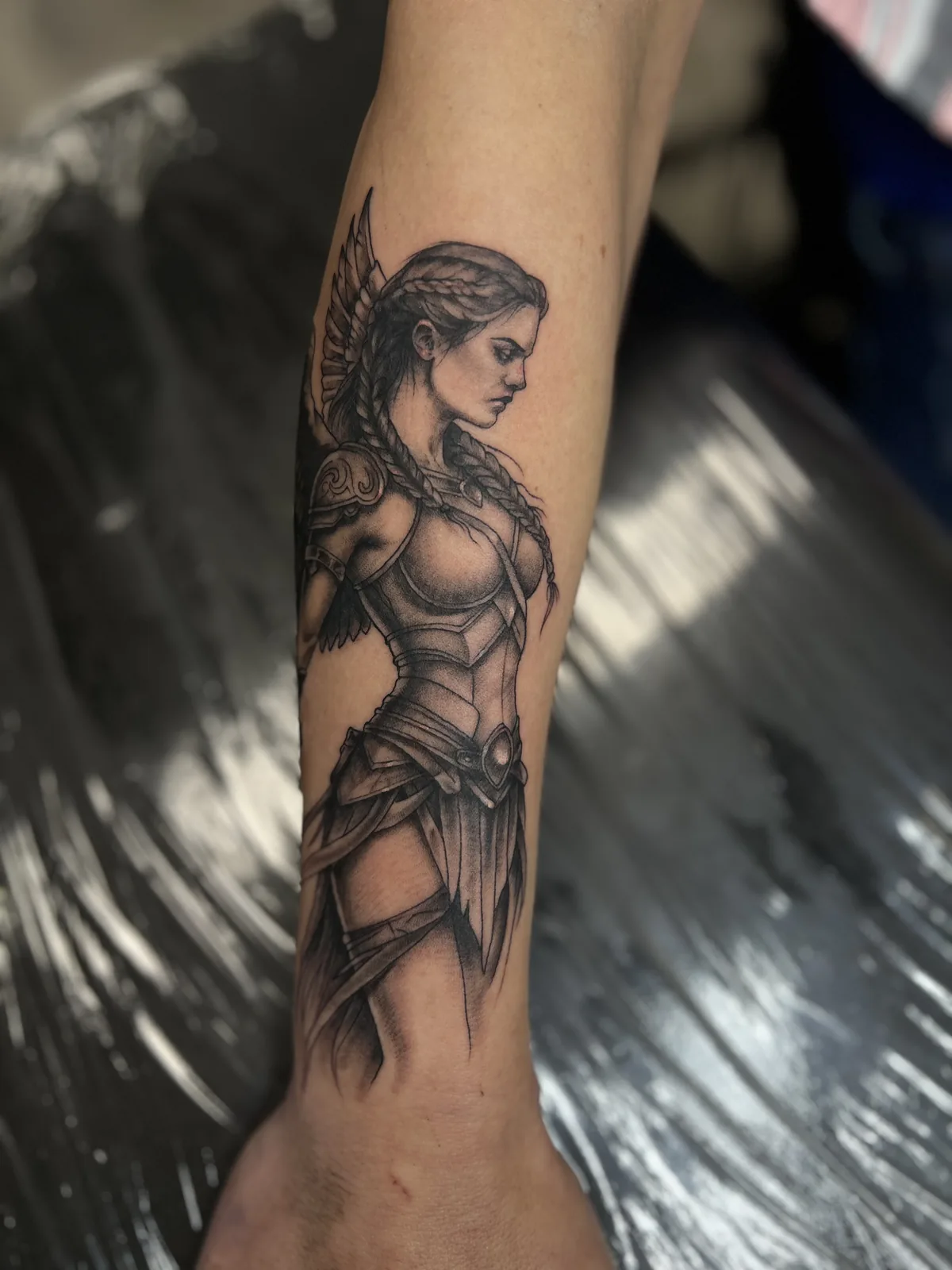 black and gray winged warrior woman forearm tattoo jeff thibodaux tattootopia