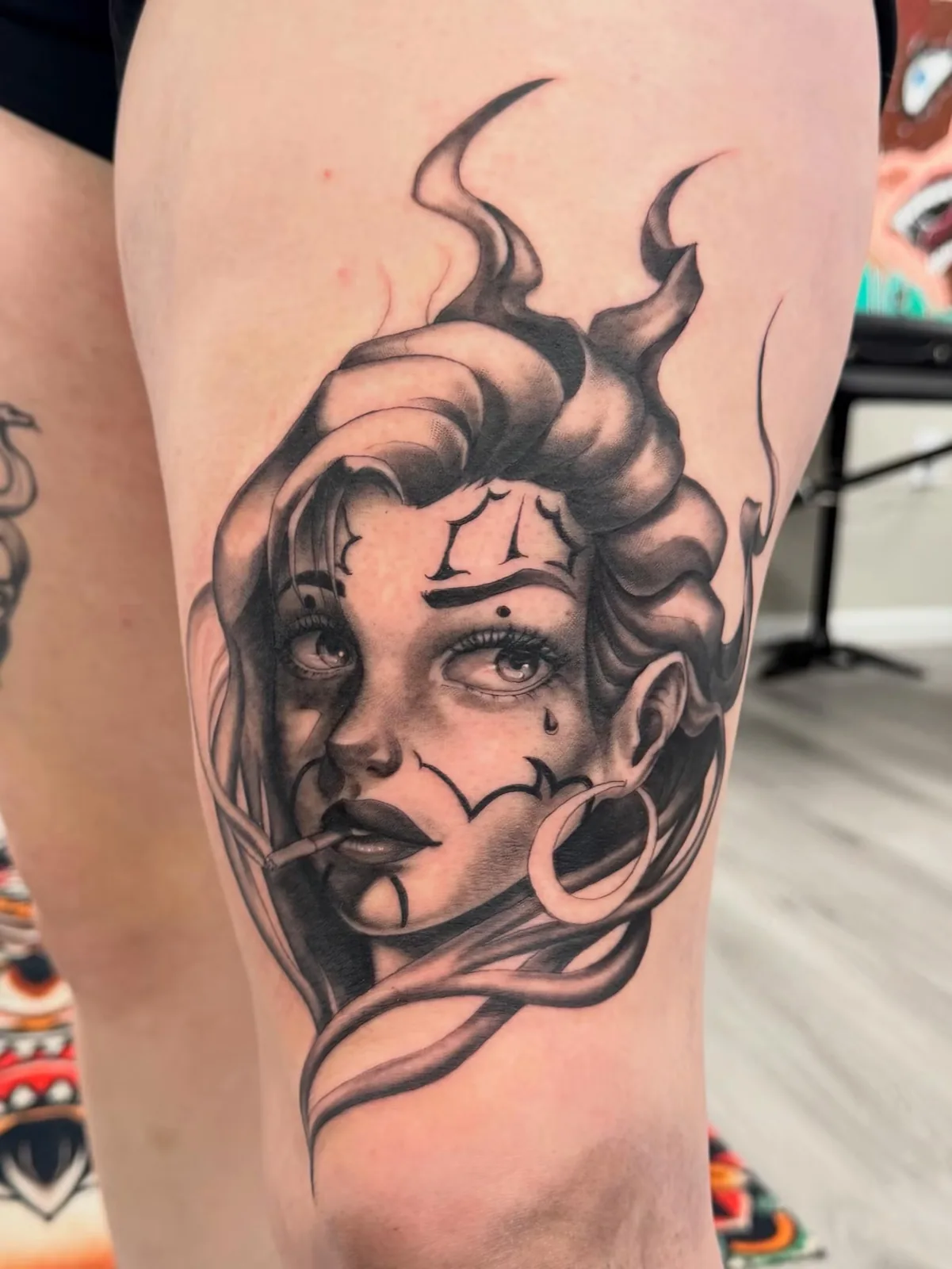 black and gray woman face with flames thigh tattoo josh lockhart tattootopia