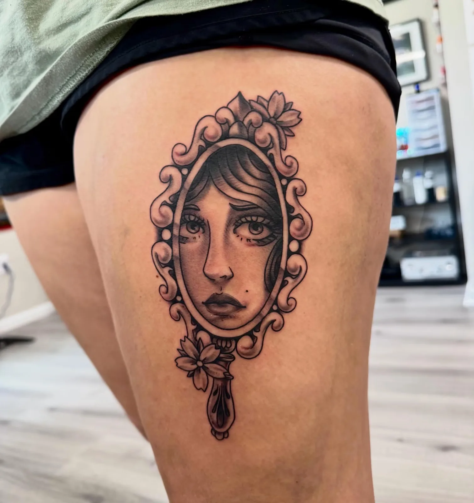 black and gray woman portrait in ornate mirror thigh tattoo josh lockhart tattootopia