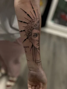 black and gray woman portrait with rays forearm tattoo jeff thibodaux tattootopia