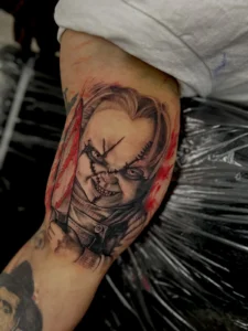 color horror doll portrait arm tattoo jeff thibodaux tattootopia