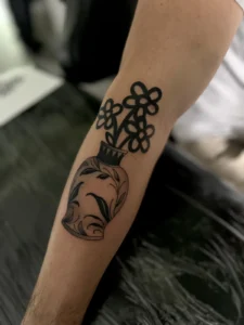 fine line flowers in a vase arm tattoo jeff thibodaux tattootopia