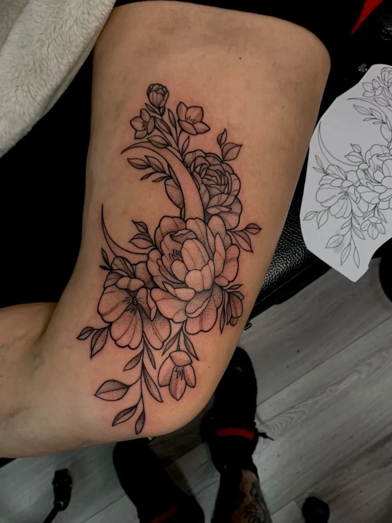 fine line peony flowers thigh tattoo jeff thibodaux tattootopia