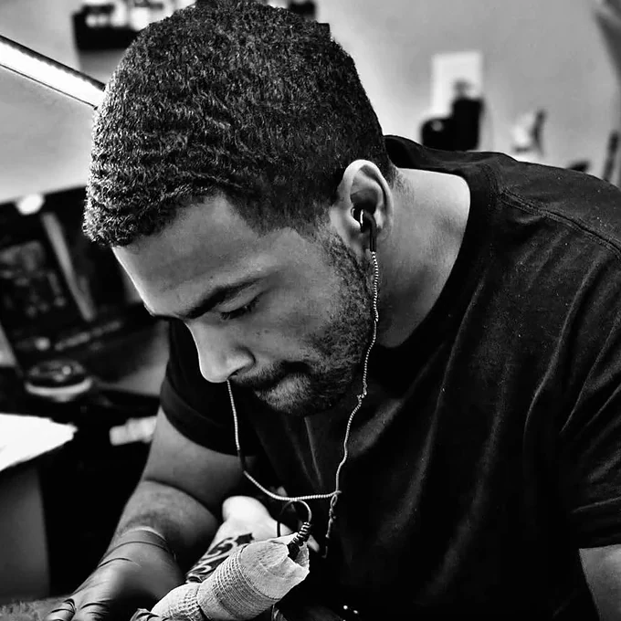 Halo Minier tattooing a client at Tattootopia in Denham Springs